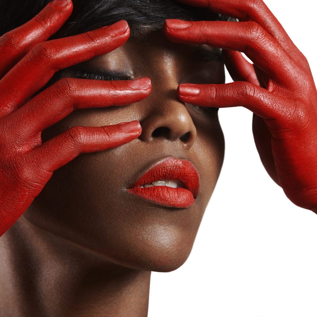 beauty black woman with a red lips and red hands